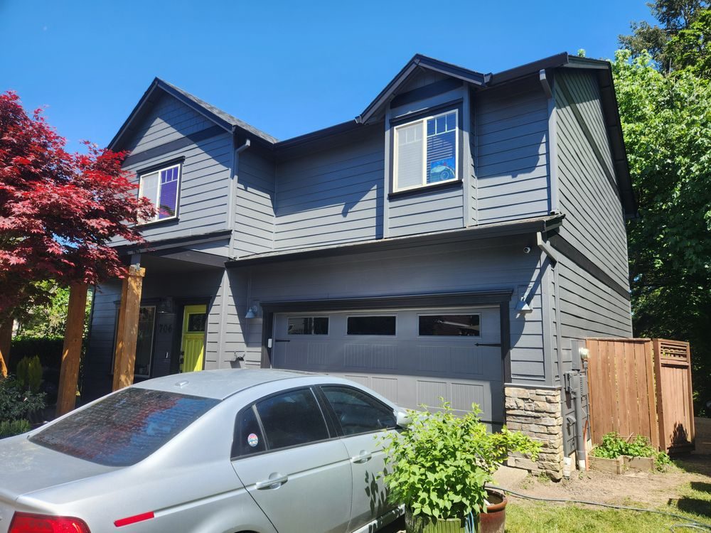 Charcoal grey two-storey home with fresh exterior paint