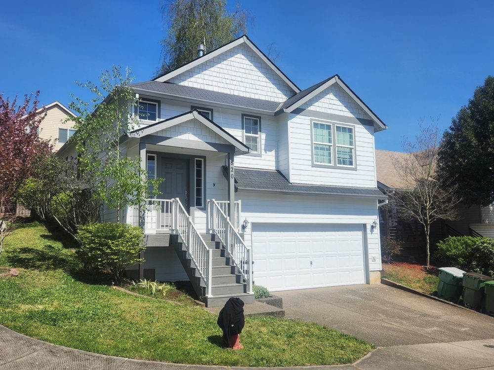 Pale blue two-storey home with white trim, freshly painted