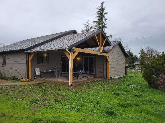 Timber-frame covered patio built onto the back of a house